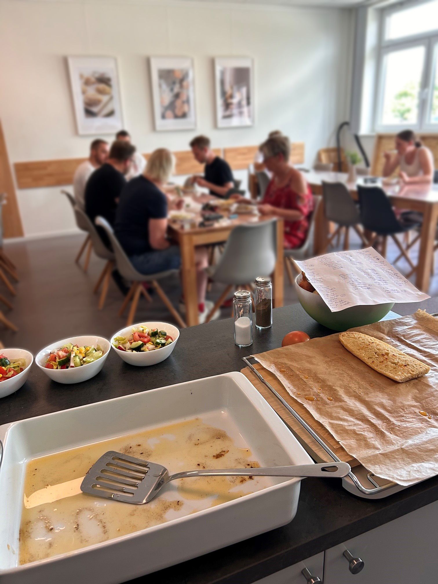 Essen im Vordergrund und Kollegen am Tisch unscharf
