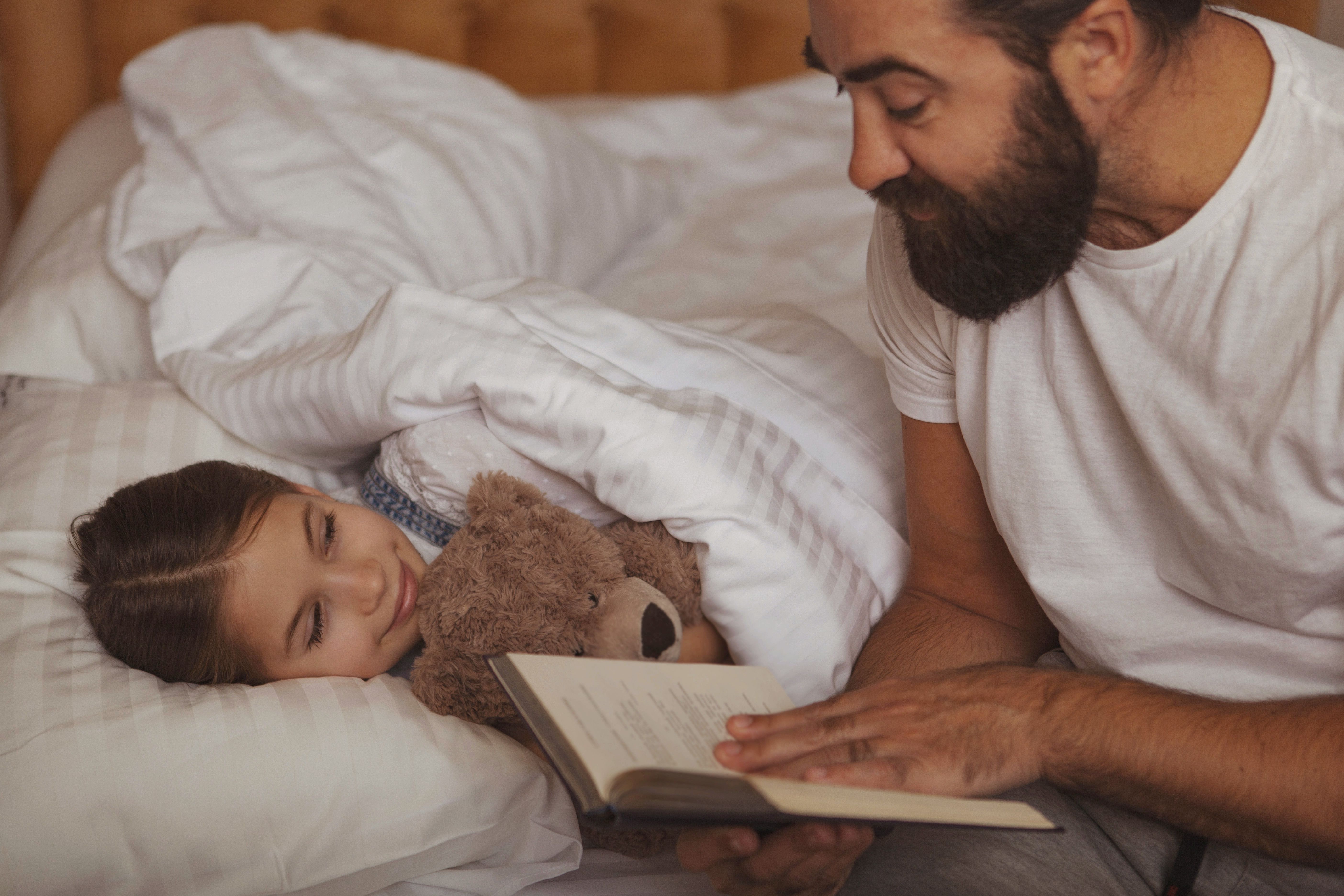 happy family father and child reading book in tent at hom